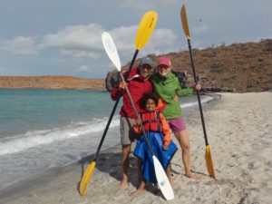 Alex Alderman with kayak paddles and family