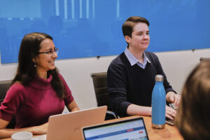 Image of two Elevate employees sitting at a table.