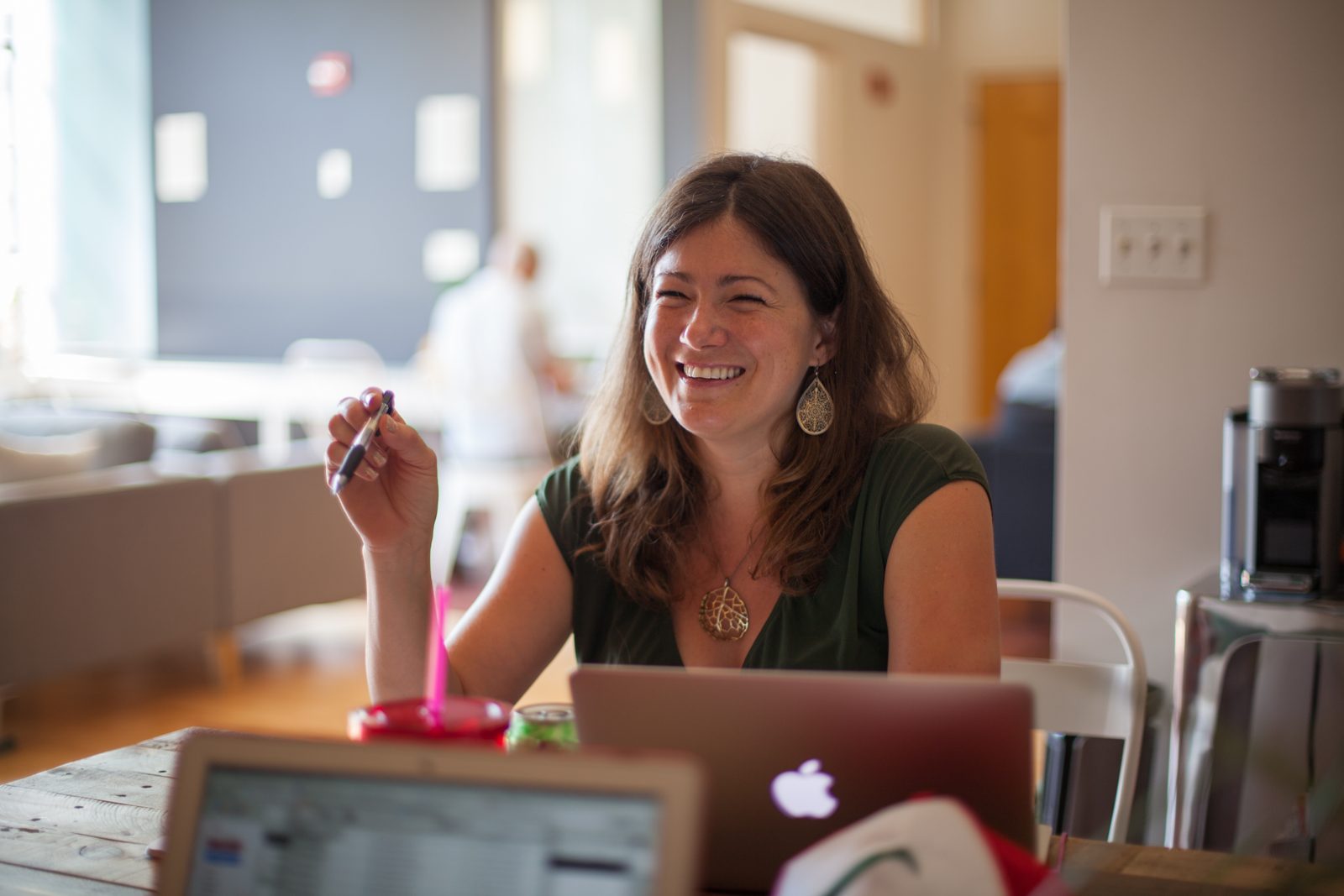 Smiling Elevate team member working at a laptop